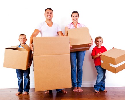 Removal team handling boxes in a Shoreditch apartment move
