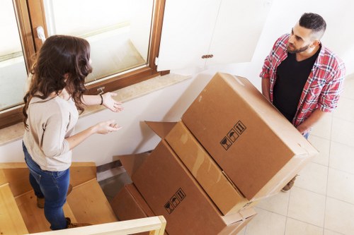 Piano movers navigating a narrow staircase in a Shoreditch apartment building